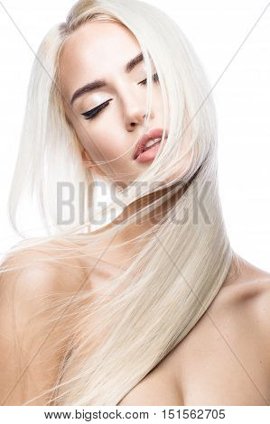 Beautiful blond girl in move with a perfectly smooth hair, and classic make-up. Beauty face. Picture taken in the studio.