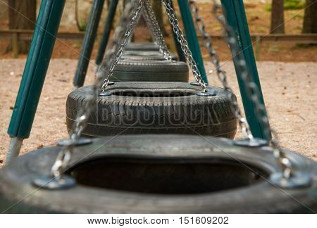 Swings in line quietly while waiting for the children to come to rock in them.