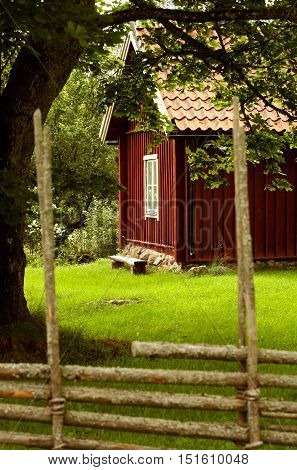 Pasture land and house in Sweden is separated by a fence.