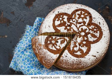 Baking in multicooker. Delicious homemade cake with cottage cheese and chocolate pieces on a dark iron textured surface