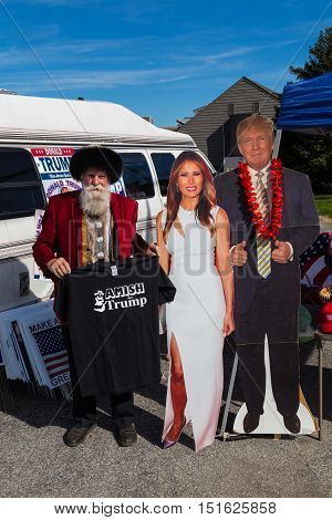 Ronks PA USA - October 11 2016: Standing with cutouts of Donald Trump and his wife a vendor holds Amish for Trump shirts for sale in Lancaster County.
