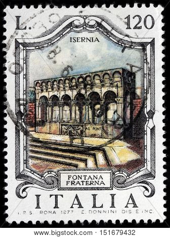 LUGA RUSSIA - JUNE 25 2016: A stamp printed by ITALY shows view of The famous Fraterna Fountain the Isernia town's main symbol Italy circa 1977