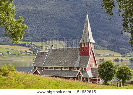Traditional norwegian red stave church. Rodven. Travel Norway. Horizontal