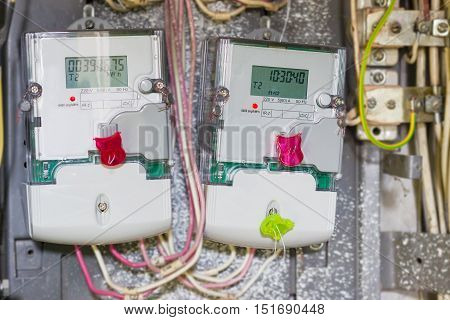 Two domestic digital solid-state electricity meter in transparent plastic case with variable-rate meters mounted in distribution board