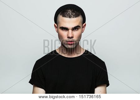 Front view of confident motionless man looking at camera. Studio shot.