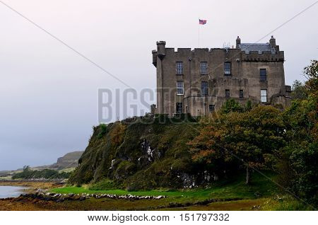 Dunvegan Castle standing on a cliff in Scotland.