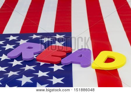 READ word on American flag emphasizes national education policy highlighting literacy and accountability. Concept focus on basic skills and learning as critical issues for schools parents pupils and nation.