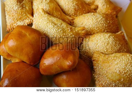 country pies with meat and seasame seeds close up photo