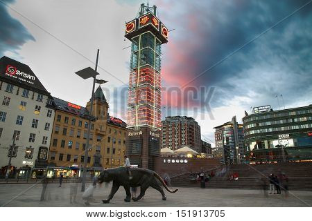 OSLO NORWAY - AUGUST 17 2016: Many people walking on wonderful Plaza in front of Oslo Central station at twilight in Oslo Norway on August 172016.