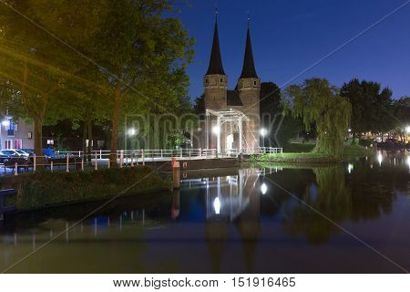 Eastern Gate, Oostpoort, with the white draw bridge, along Delftse Schie canal at night, Delft, Holland, Netherlands