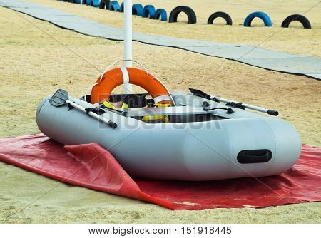 Inflatable Rescue Boat. Gray Inflatable Boat On The Beach In The Sand