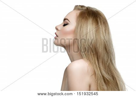 Profile portrait of beautiful young woman with messy long blond hair and bright makeup. Beauty shot. Isolated over white background. Copy space.