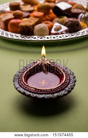 Mix Mithai and diya on diwali festival