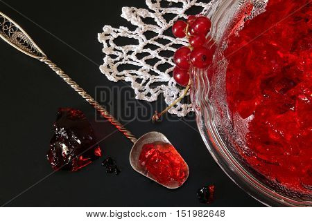 Red Currant Jelly In Glass Bowl Against Black Background