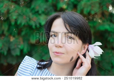 Beautiful Girl With Dark Hair And Different Eye Color Heterochromia . Smiles At The Photos In The Pa