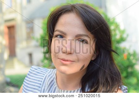 Beautiful Girl With Dark Hair And Different Eye Color Heterochromia . Smiles At The Photos In The Pa