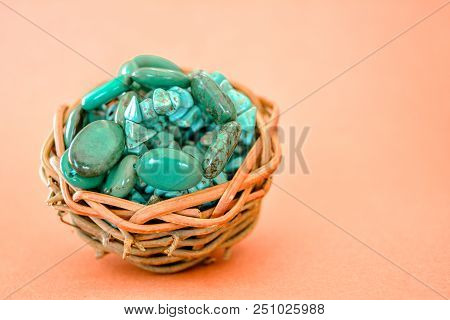 Pile Stones Of Raw Turquoise In Small Wooden Nest On A Brown Background. Blue And Green Color Stones