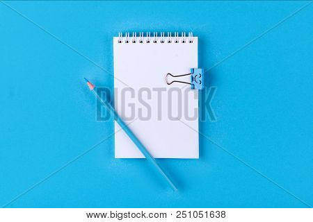 Top View Of Blank Notebook With Peb On Colorful Background Blue With Copy Space.