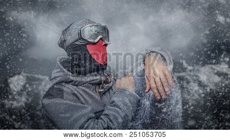 Portrait Of A Snowboarder Dressed In A Full Protective Gear For Extream Snowboarding Posing With Sno
