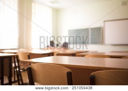 School Classroom In Blur Background Without Young Student.