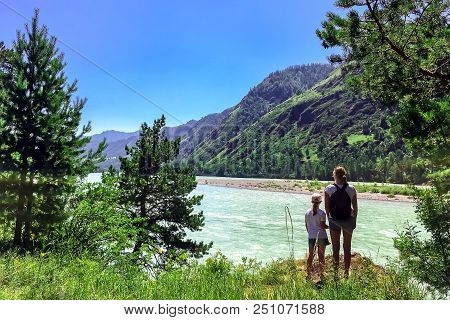 Woman And Child Looking Into The Distance To The Mountains, The River, Traveling With Family In The 