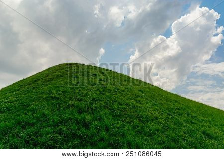 Summer Background. Warm Sunny Weather On A Green Grass Hill. A Blue Sky With White Clouds