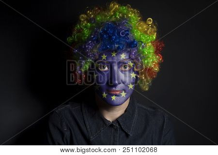 Funny Clown Woman With Painted European Union Flag Isolated On Black Background