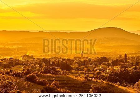 French Town, Fields And Vineyards At Sunset. Beautiful Scenic View Of Barjac City, South France, Eur