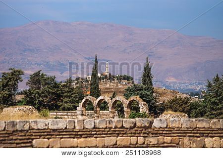 Mosque On A Hill With Mountains In The Background On A Sunny Day And Blue Sky At Anjar, Bekaa Valley