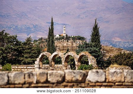 Mosque On A Hill Surrounded By Pine Trees With Mountains In The Background On A Sunny Day At Anjar, 