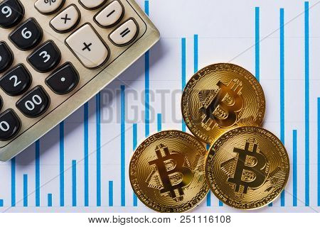 Bitcoins And Caculator On A Chart As Financial Concept