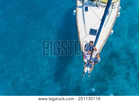 Aeiral View Of Happy Family With Adorable Daughter And Son Resting On A Big Yacht. Drone Photography