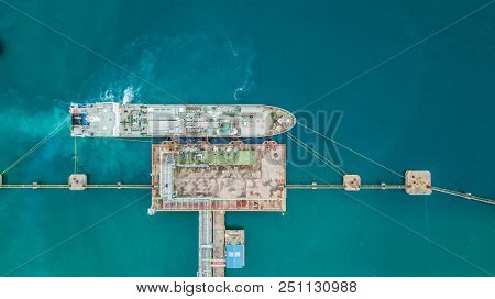 Aerial Top View Of Oil Tanker Ship At The Port, Aerial View Oil Terminal Is Industrial Facility For 