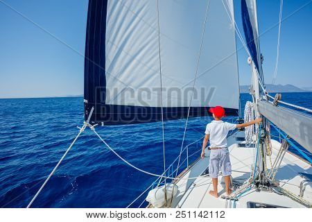 Back View Of Cute Boy On Board Of Sailing Yacht On Summer Cruise. Travel Adventure, Yachting With Ch