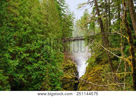 View of the bridge over Englishman River upper waterfalls section located in Vancouver Island, BC Canada