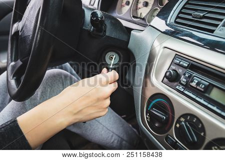 The Girl Starts The Car By Inserting The Ignition Key Into The Lock.