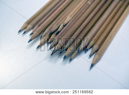 Many Brown Pencils Are Placed On Paper.
