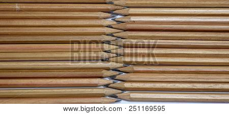 Many Brown Pencils Are Placed On Paper.