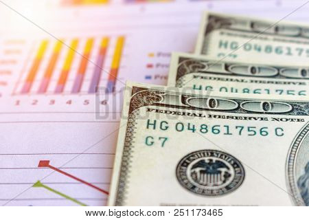 Banknote And Coins Depicted On Economic Graphs Dollar Currency, Financial Investment Concepts That A