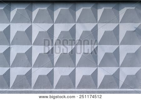 Background, Wall Of Large Gray Brick Blocks With Triangular Patterns And Sun Shadows