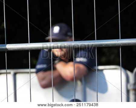 Fence With Policeman In Background During Protests In Front Of Polish Senate And Parliament, July 24