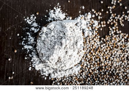 Close Up Of Flour Of Pearl Millet Or Bajra Ka Atta With Raw Pearl Millet On A Wooden Surface In Dark