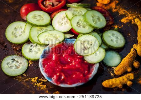 Close Up Ingredeints Of Ayurvdic Face Pack Of Vegetables I.e. Sliced Cucumber,tomato Puree,and Turme