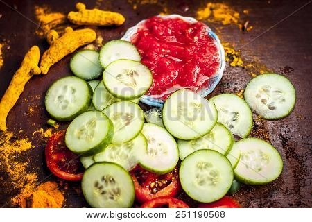 Close Up Ingredeints Of Ayurvdic Face Pack Of Vegetables I.e. Sliced Cucumber,tomato Puree,and Turme