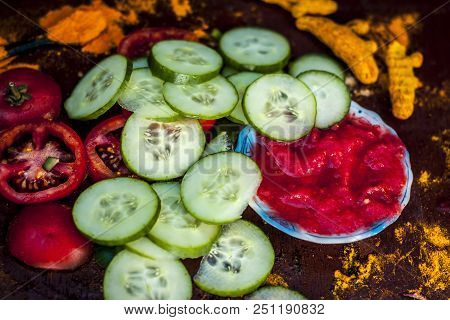 Close Up Ingredeints Of Ayurvdic Face Pack Of Vegetables I.e. Sliced Cucumber,tomato Puree,and Turme