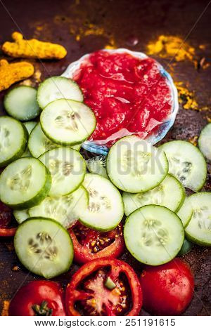 Close Up Ingredeints Of Ayurvdic Face Pack Of Vegetables I.e. Sliced Cucumber,tomato Puree,and Turme