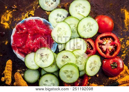 Close Up Of Ingredients An Face Pack Of Raw Fresh Vegetables  On Gothic Surface I.e. Tomato Puree An