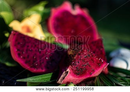 Fresh Red Dragon Fruit On Green Leaf With Stones