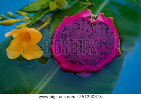 Exotic Dragon Fruit Dropped Into Water Isolated On White.