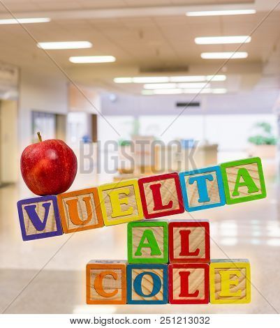Vuelta Al Cole Translates To Back To School In Spanish With Wooden Blocks With Red Apple On Top. Bac